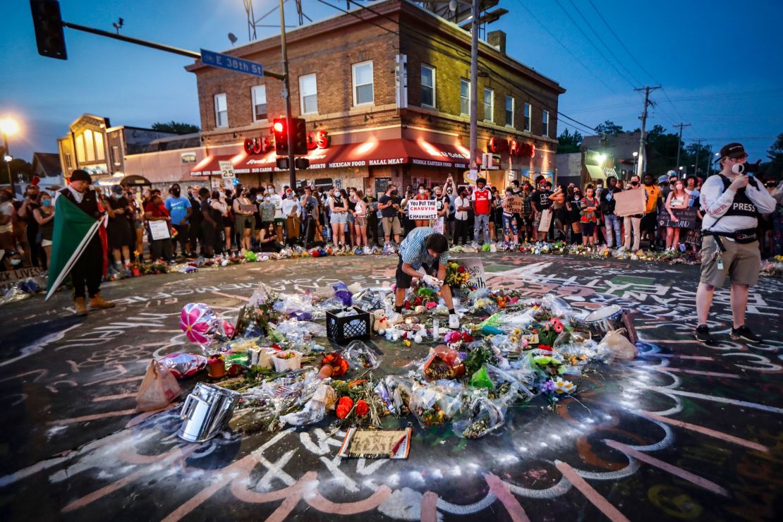 Mourners gather at a memorial for Floyd outside a Minneapolis convenience store. Floyd was arrested after allegedly trying to use a counterfeit bill.