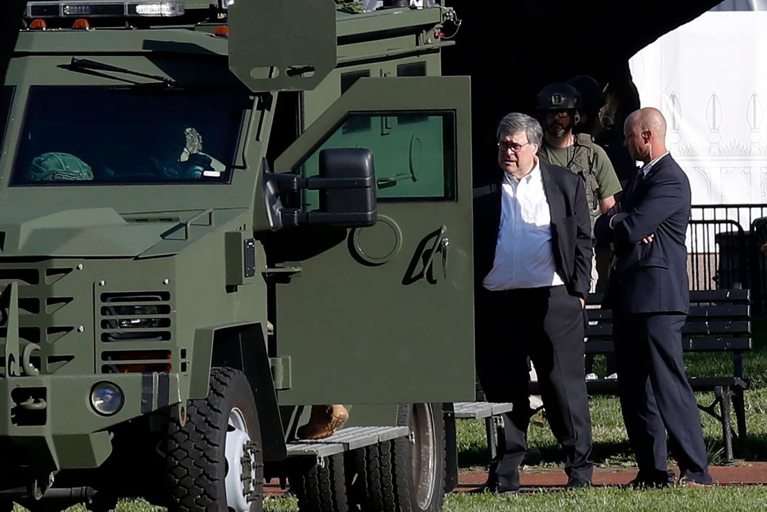 Attorney General William Barr stands in Lafayette Square across from the White House as demonstrators gather to protest the death of George Floyd.