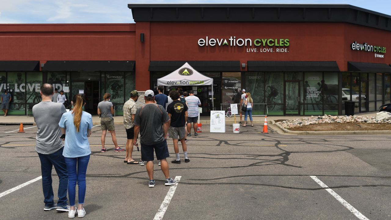 Customers wait outside to enter a bike shop in Highlands Ranch, Colorado. (Photo by RJ Sangosti/MediaNews Group/The Denver Post via Getty Images)