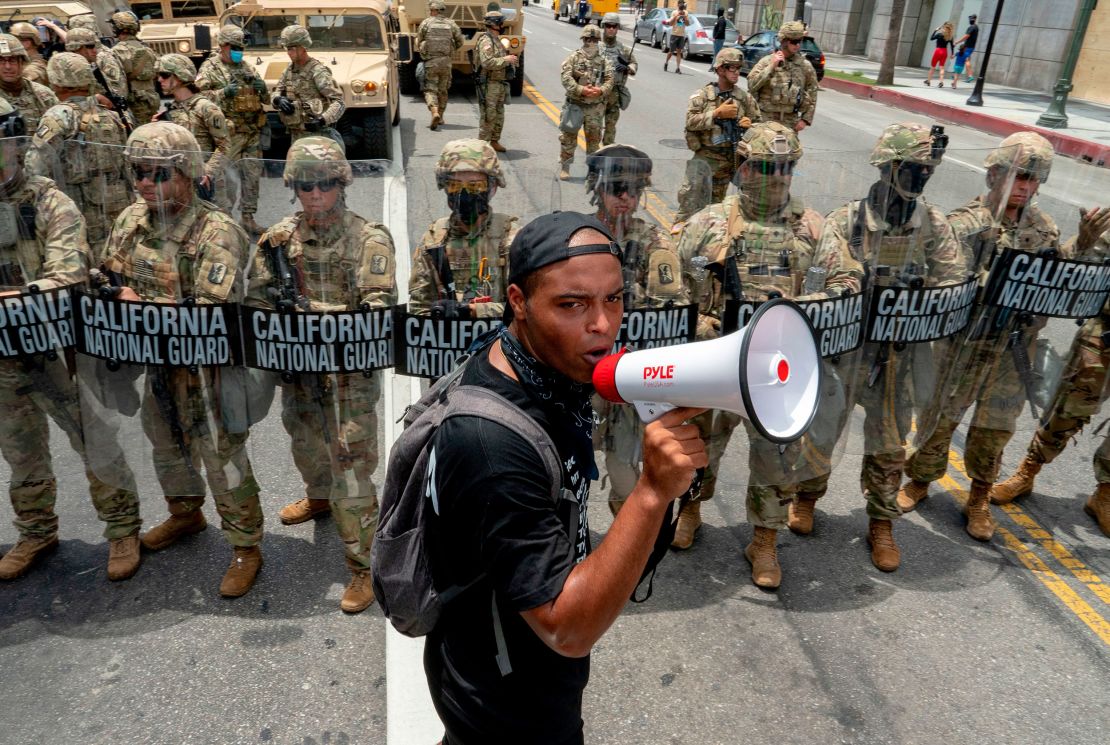 A protester speaks in front of the California National Guard during a demonstration in Los Angeles.