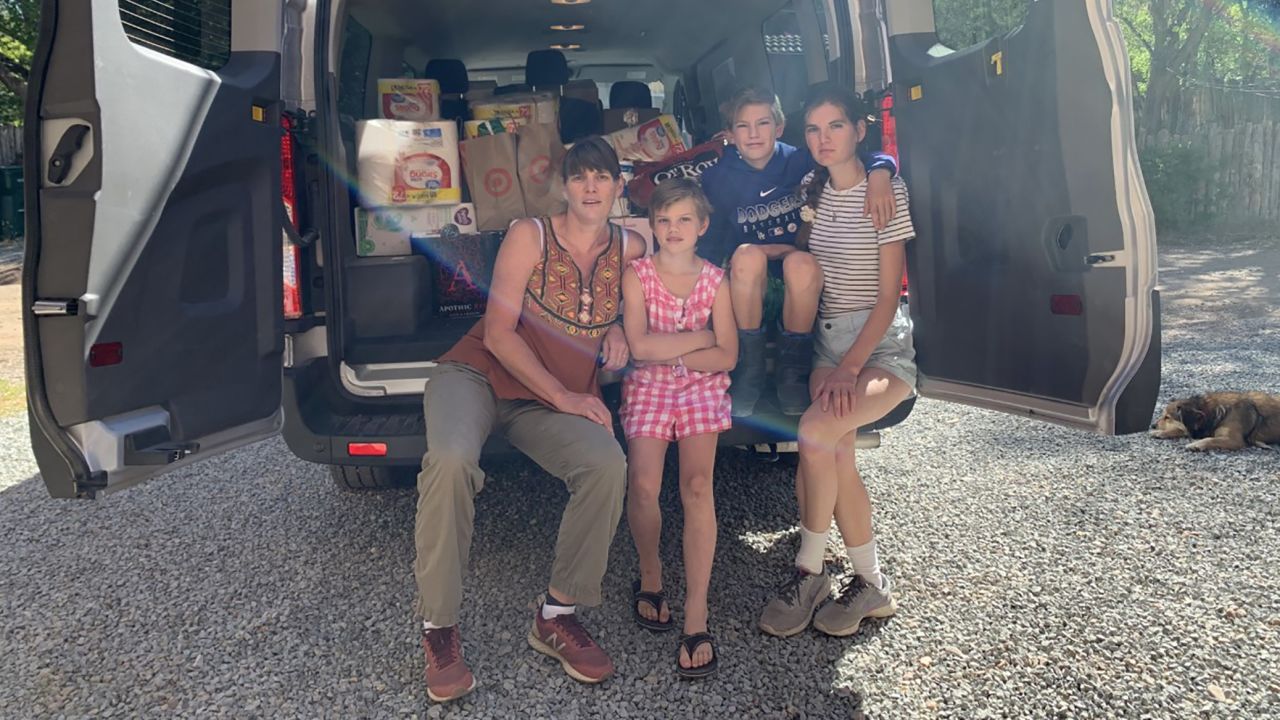Jess Falkenhagen and a few helpers load a van before delivering supplies to the Navajo reservation in Window Rock, Arizona. 