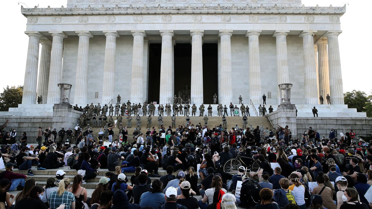 Members of the D.C. National Guard stand on the steps of the Lincoln Memorial monitoring a large crowd of demonstrators participating in a peaceful protest against police brutality and the death of George Floyd.