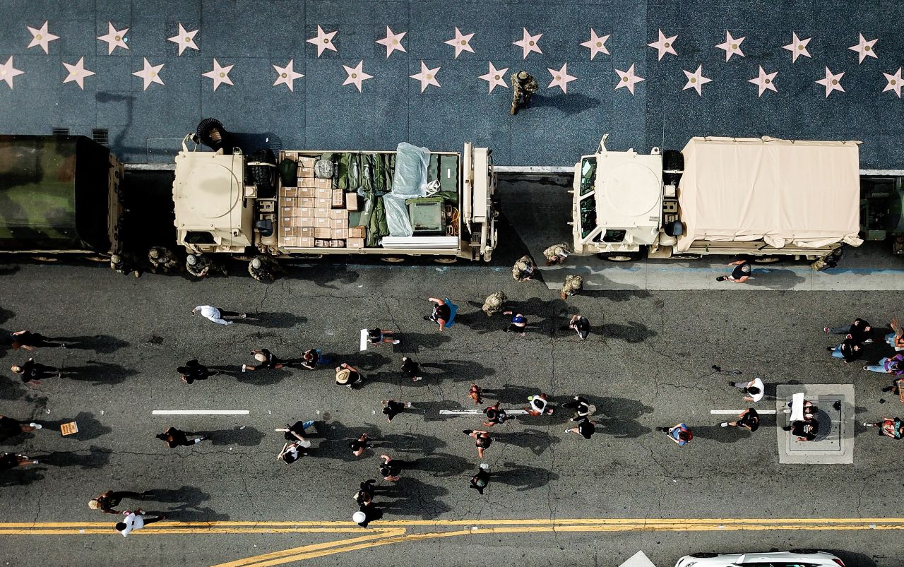 Members of the National Guard watch as demonstrators march along Hollywood Boulevard in Los Angeles on June 2.