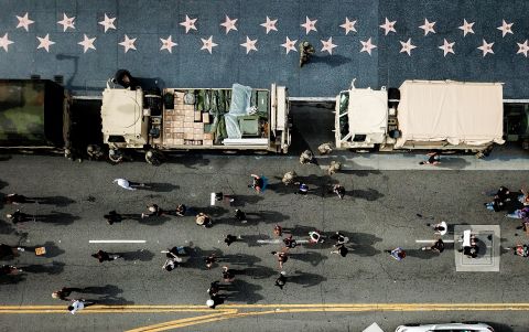 Members of the National Guard watch as demonstrators march along Hollywood Boulevard in Los Angeles on Tuesday, June 2.
