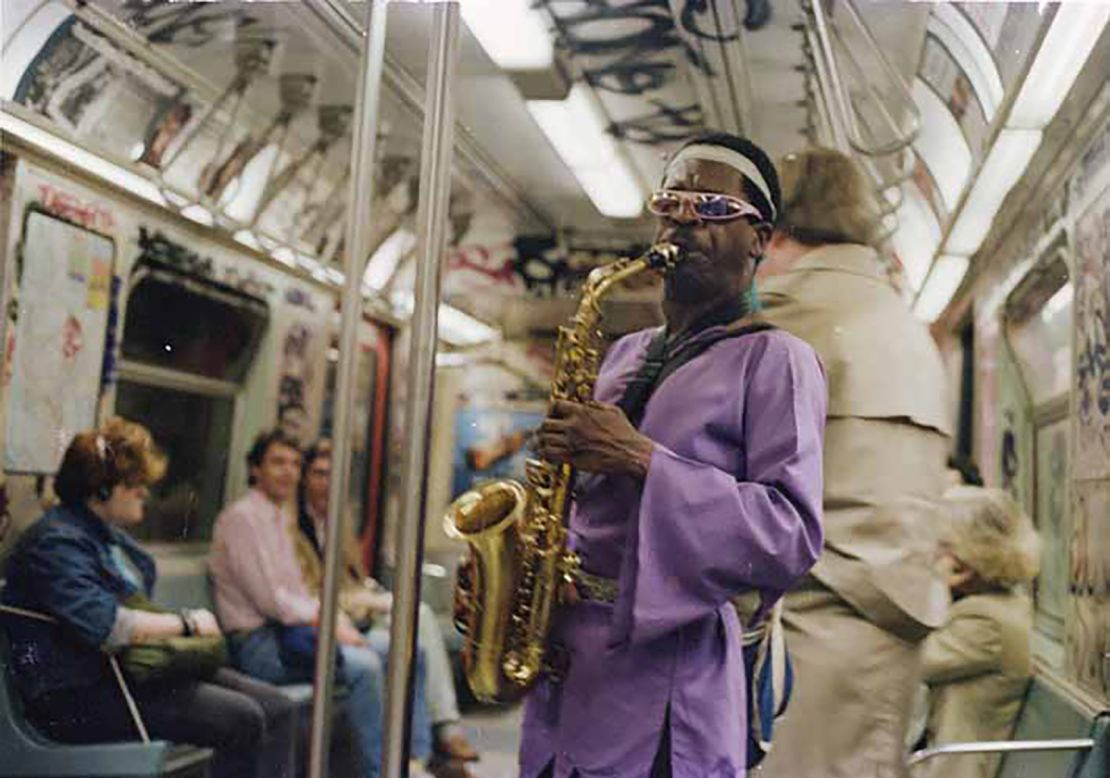 The photographer captures an array of individuals, including performers, who make up the vivid tapestry of the metro system.