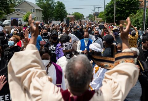 A group of clergy members stops and prays during a march to a George Floyd memorial in Minneapolis on June 2.