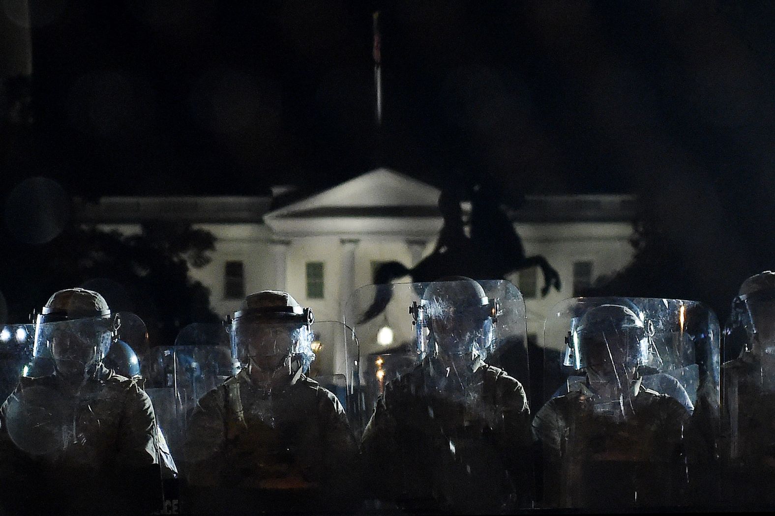 Police officers hold a perimeter June 2 behind a metal fence that was recently erected in front of the White House.