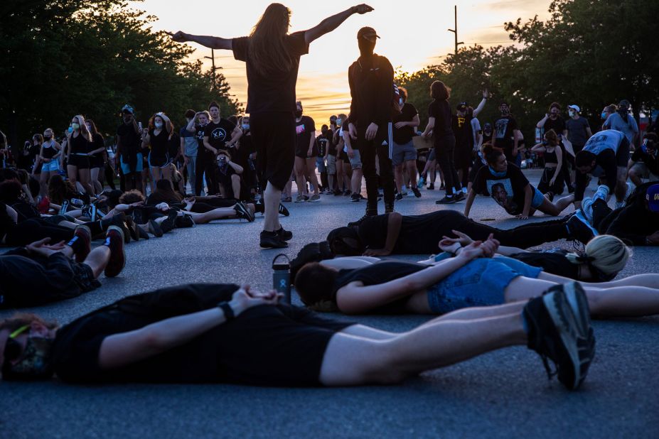 Protesters lie down in an intersection, blocking traffic in Coralville, Iowa, on June 2.