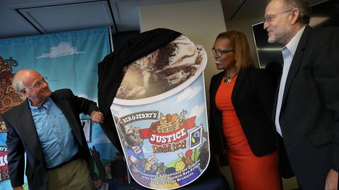Ben & Jerry's co-founders Ben Cohen (L) and Jerry Greenfield (R) unveil Justice Remix'd during a press conference with Advancement Project executive director, Judith Dianis (C).
