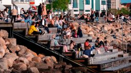 People enjoy socializing outdoors in Malmo, Sweden, on May 26 