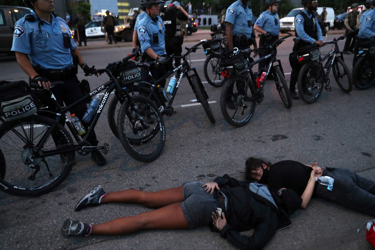 Protesters lie face-down in front of law enforcement officers in Minneapolis on Sunday.