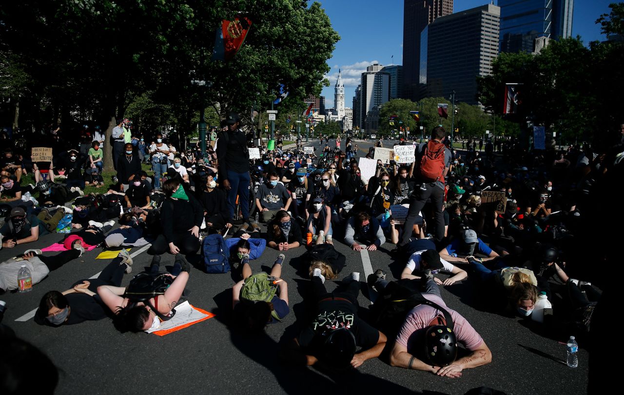 Protesters lie down on Benjamin Franklin Parkway in Philadelphia on Monday.