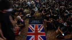 A British Union Jack flag is displayed as protesters gather along a fenced-off Victoria Harbour pier in Hong Kong, late on June 28, 2019, before midnight, when China's People's Liberation Army (PLA) will automatically be granted control of the pier under a 1994 British and Chinese agreement. - Hong Kong protesters called for G20 nations to confront fellow member China over sliding freedoms in the financial hub. (Photo by Anthony WALLACE / AFP)        (Photo credit should read ANTHONY WALLACE/AFP via Getty Images)