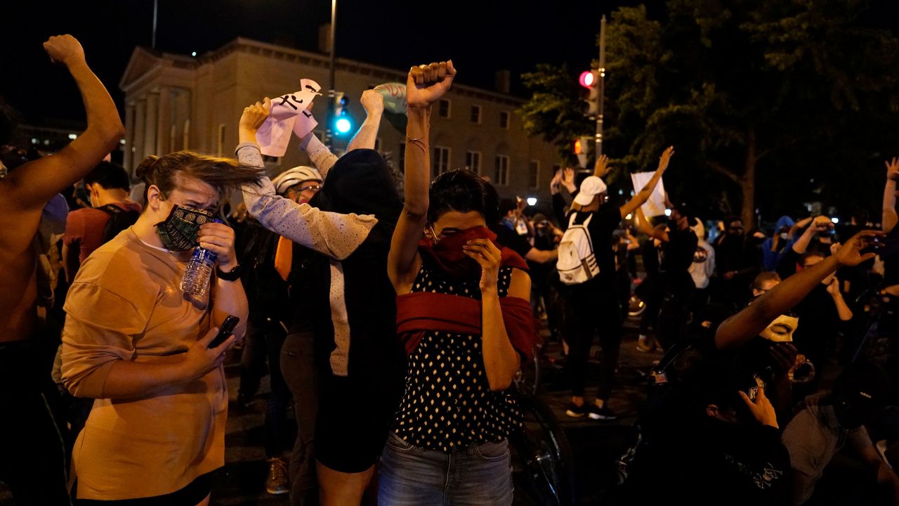 Demonstrators react as a helicopter circles low as people gather to protest the death of George Floyd, Monday, June 1, 2020, near the White House in Washington. Floyd died after being restrained by Minneapolis police officers. (AP Photo/Evan Vucci)