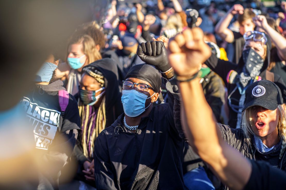 Protesters raise their hands in front of police in Minneapolis, Minnesota, on May 29, during a demonstration over the death of George Floyd.