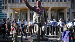 Police stand near a vandalized statue of controversial former Philadelphia Mayor Frank Rizzo on May 30 in Philadelphia during protests over the death of George Floyd.