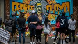 In this May 31, 2020 file photo, visitors make silent visits to organic memorial featuring a mural of George Floyd, near the spot where he died while in police custody, in Minneapolis, Minn. The message from protesters around the United States is that George Floyd is the latest addition to a grim roster of African Americans to be killed by police.  (Bebeto Matthews/AP)