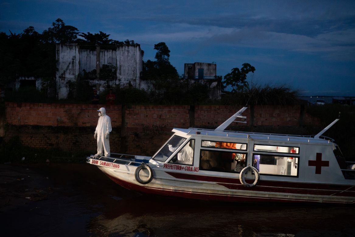 A health worker stands on a boat while waiting for an ambulance to help transfer a coronavirus patient in Manacapuru, Brazil, on Monday, June 1. <a href="https://www.cnn.com/2020/05/22/americas/gallery/brazil-coronavirus/index.html" target="_blank">Brazil is Latin America's hardest-hit country,</a> with confirmed coronavirus cases climbing by the thousands each day.