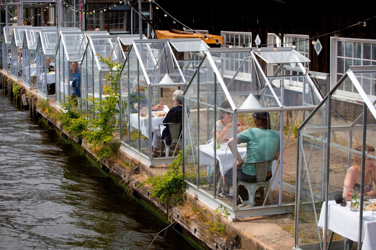 People practice social distancing June 1 as they eat inside <a href="https://www.cnn.com/2020/05/07/world/dutch-restaurant-reopen-greenhouse-trnd/index.html" target="_blank">"quarantine greenhouses"</a> at Mediamatic ETEN, a restaurant in Amsterdam, Netherlands.