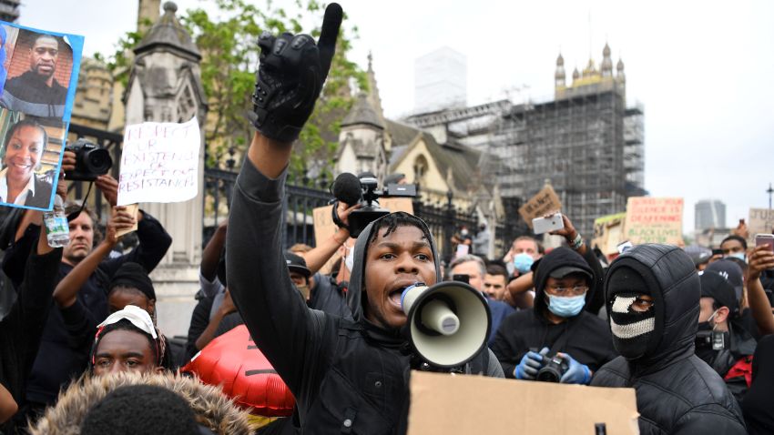 TOPSHOT - British actor John Boyega speaks to protestors in Parliament square during an anti-racism demonstration in London, on June 3, 2020, after George Floyd, an unarmed black man died after a police officer knelt on his neck during an arrest in Minneapolis, USA. - Londoners defied coronavirus restrictions and rallied on Wednesday in solidarity with protests raging across the United States over the death of George Floyd, an unarmed black man who died during an arrest on May 25. (Photo by DANIEL LEAL-OLIVAS / AFP) (Photo by DANIEL LEAL-OLIVAS/AFP via Getty Images)