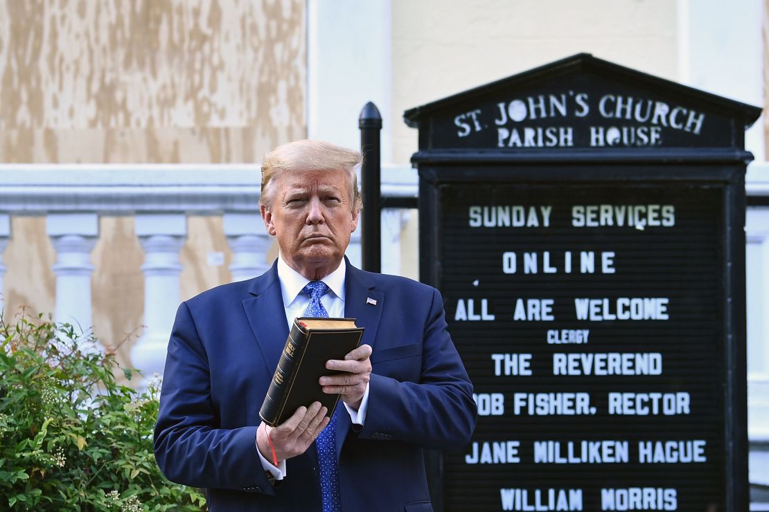 US President Donald Trump holds up a Bible outside of St John's Episcopal church across Lafayette Park in Washington.
