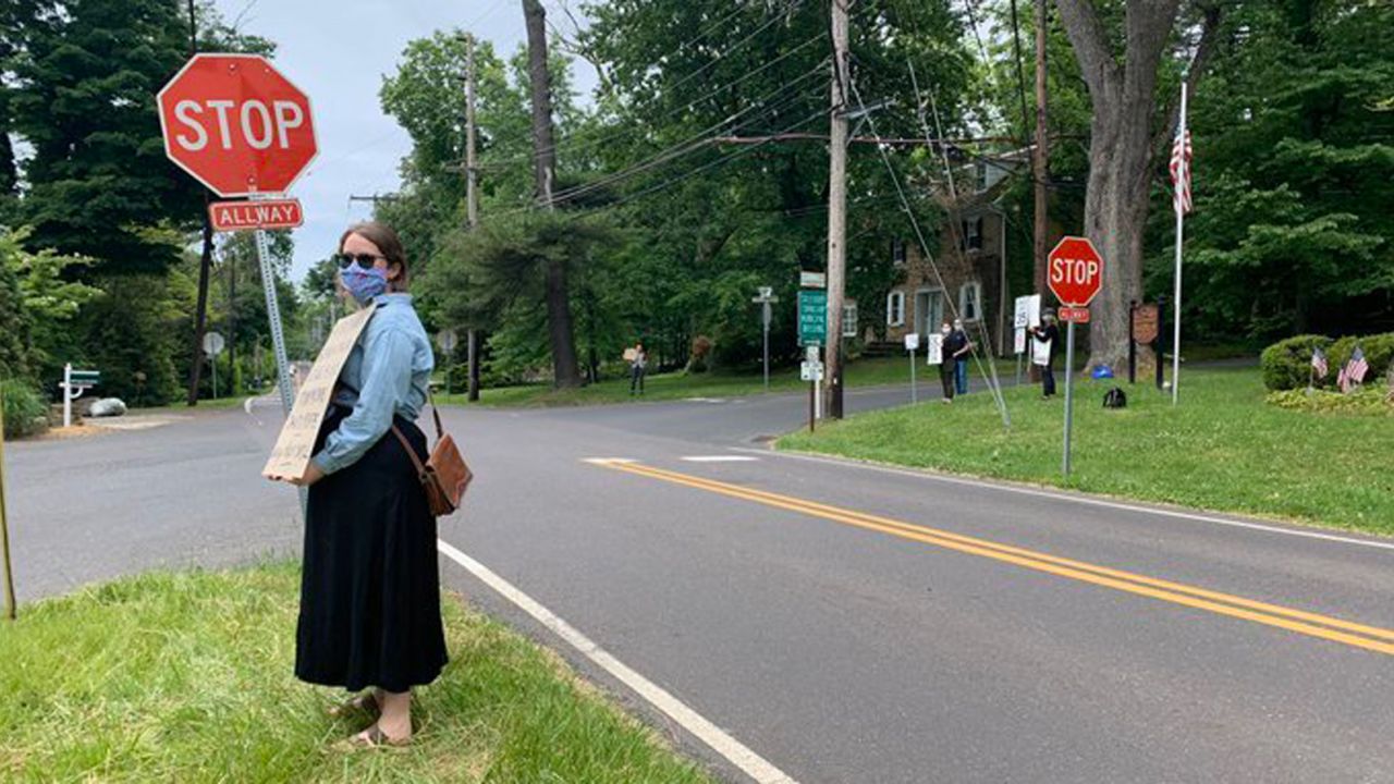 Mallory Corr took this photo of her friend, Elizabeth Lucy, holding a sign with the names of seven black Americans who died at the hands of police.