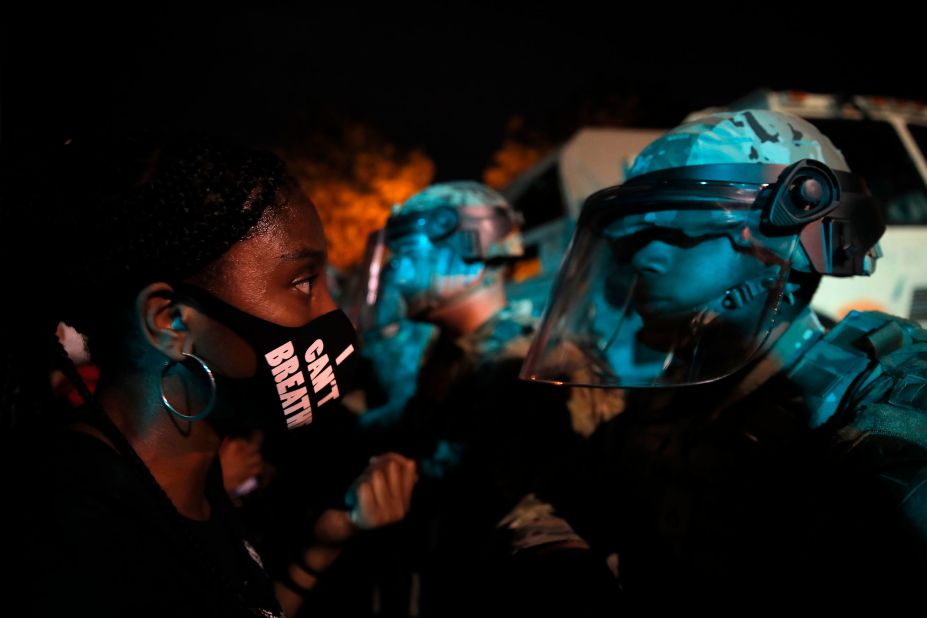 A protester faces a law enforcement officer in Washington, DC, on June 3.