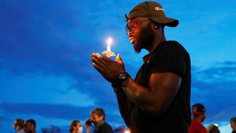 A man in Minneapolis holds a candle June 3 near the scene of George Floyd's death.