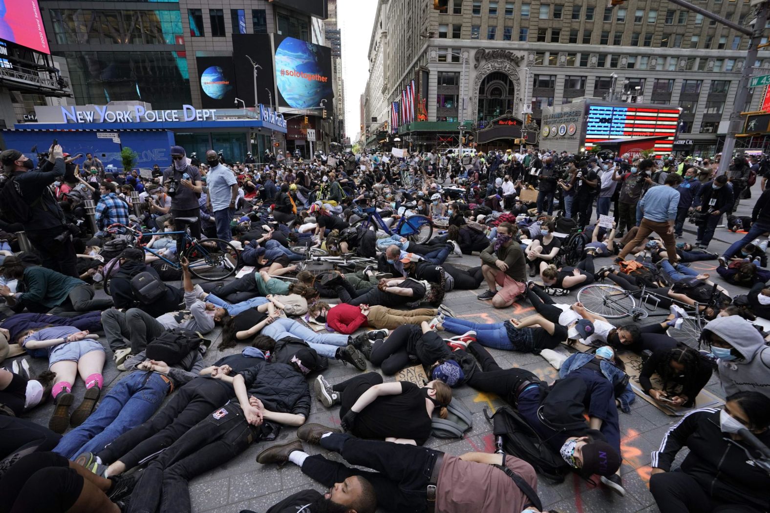 Protesters lie on the ground with their hands behind their back in New York's Times Square on Monday.