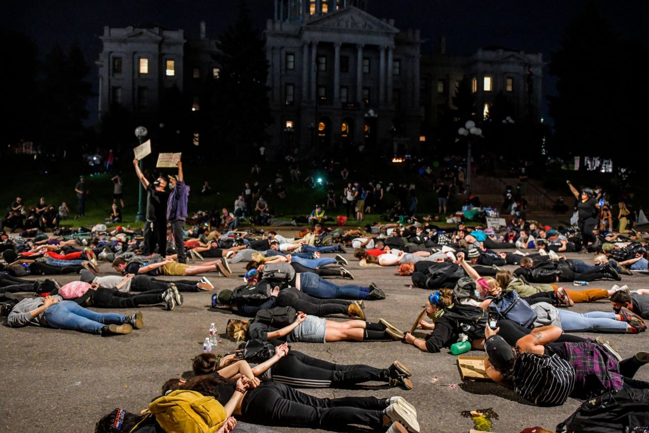 Demonstrators take to the middle of the street in front of the Colorado State Capitol in Denver on Monday.