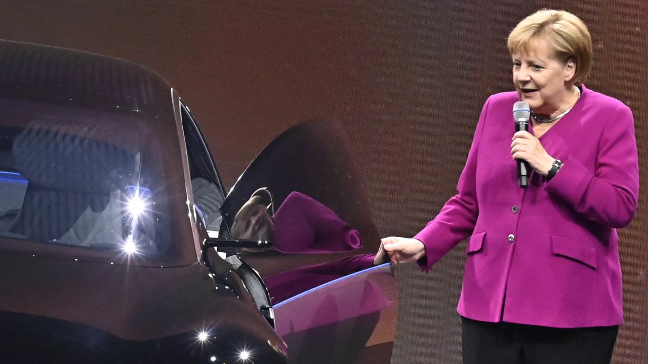 German Chancellor Angela Merkel pictured next to an electric Mercedes in 2019.