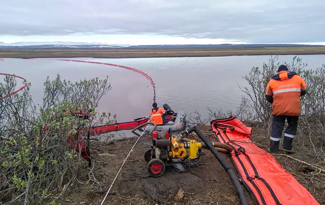 Members of the Marine Rescue Service work near the spill on Wednesday.