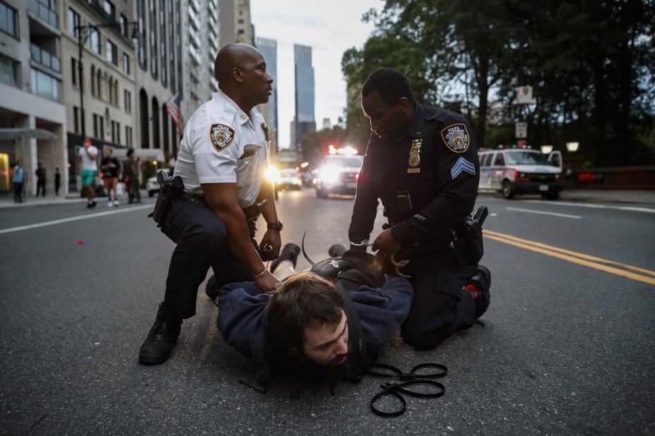 A protester is arrested for violating curfew near the Plaza Hotel in New York on June 3.