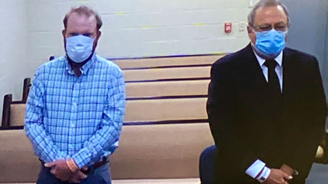 Travis McMichael, left, and Greg McMichael listen to a preliminary hearing via video feed Thursday.