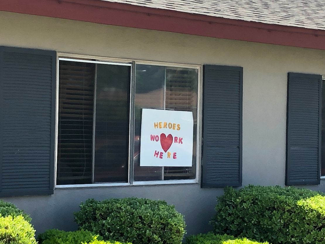 Signs in the windows of Bel Tooren express gratitude for nursing home employees during the pandemic.