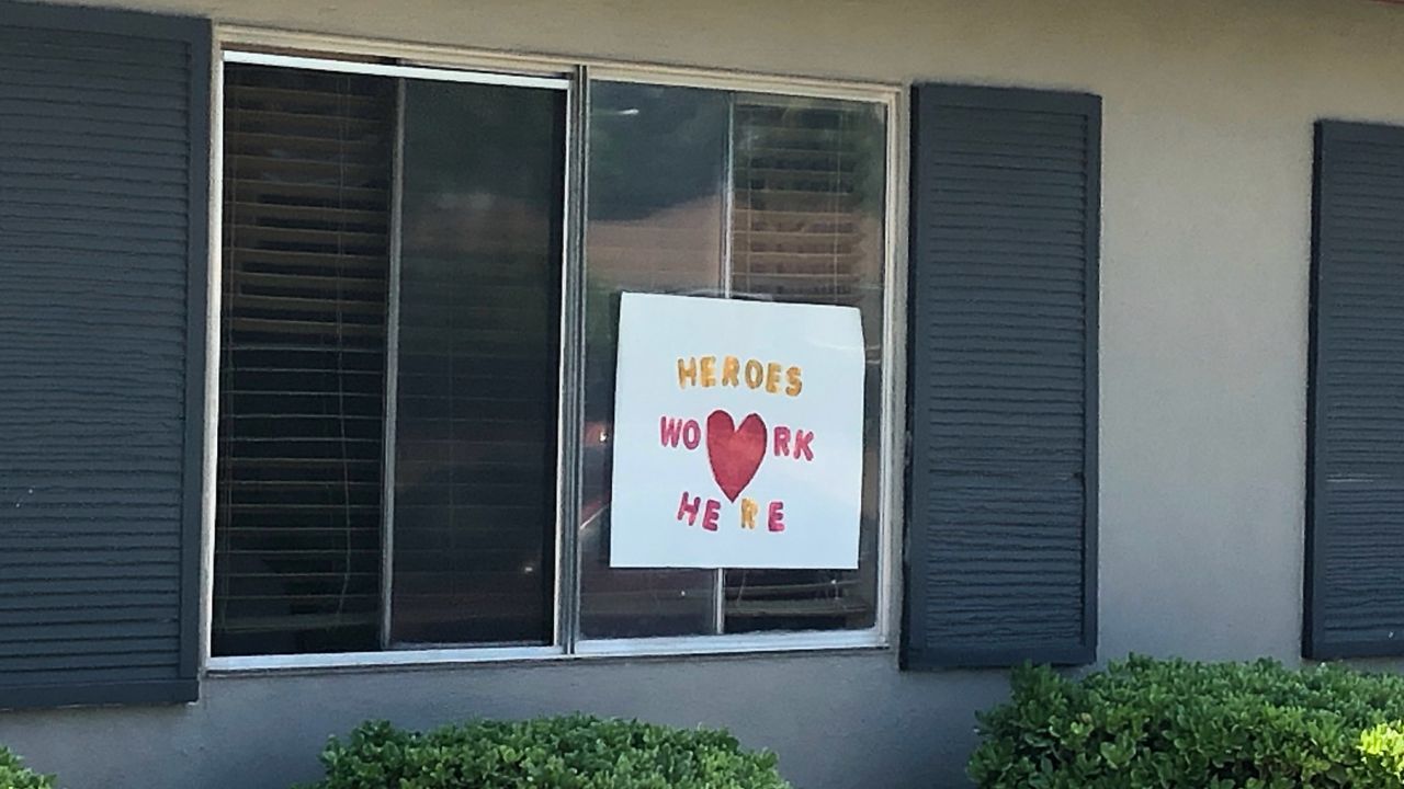 Signs in the windows of Bel Tooren express gratitude for nursing home employees during the pandemic.