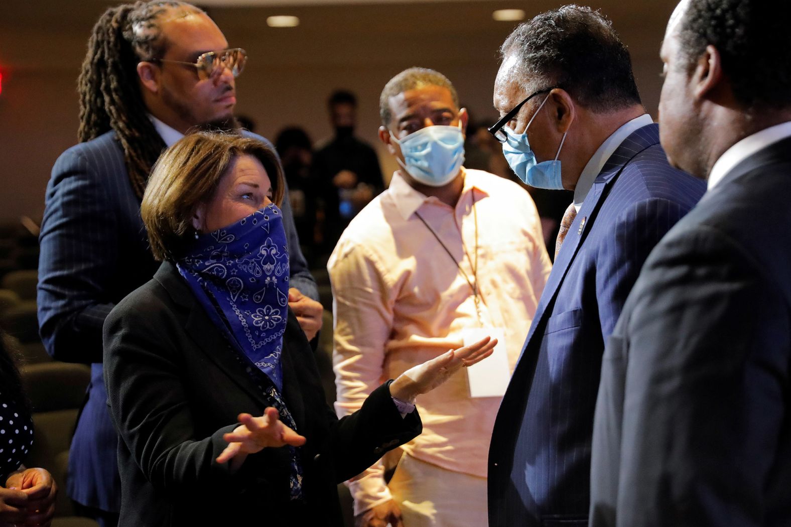 US Sen. Amy Klobuchar talks with the Rev. Jesse Jackson at the service.