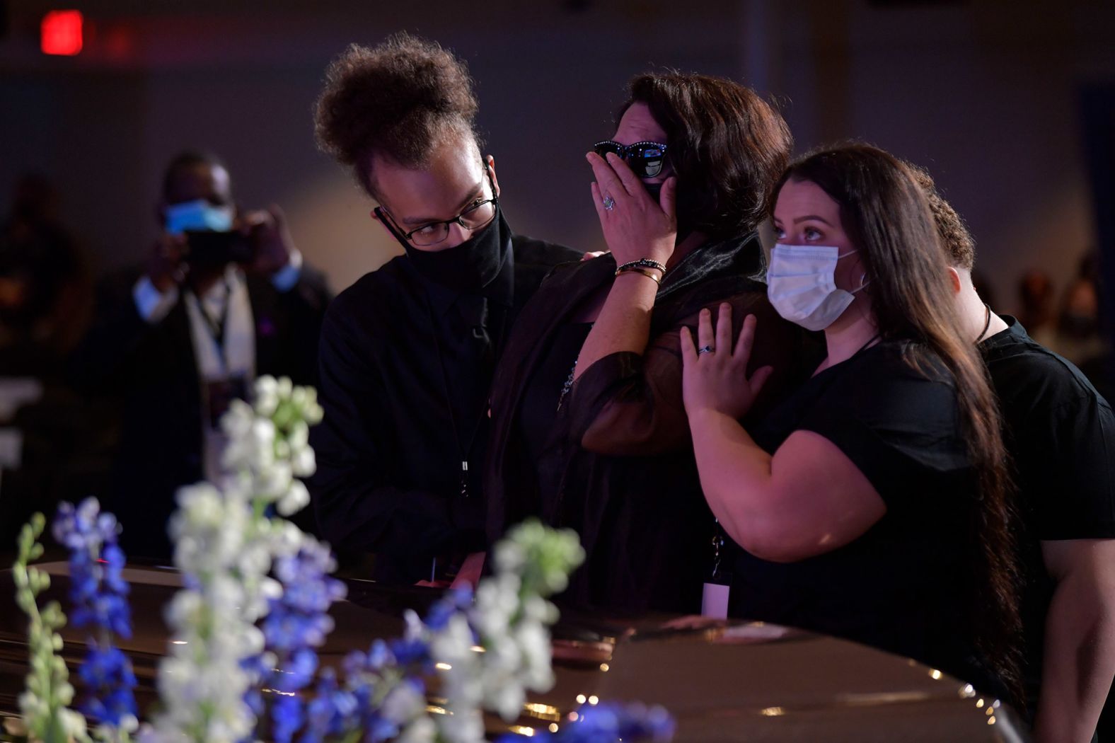 Mourners spend a moment at Floyd's casket ahead of the service.