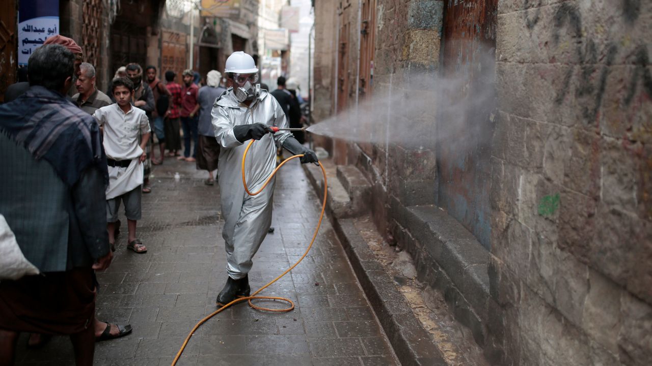 A health worker wearing a protective suit sprays disinfectant at a market in the old city of Sanaa in April.