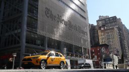 A taxi cab drives along 8th Avenue in front of the New York Times headquarters on March 9, 2020 in New York City. (Photo by Gary Hershorn/Corbis/Getty Images)