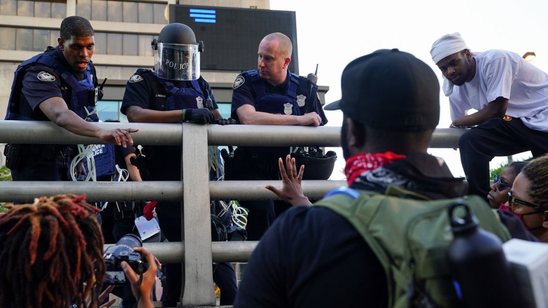 Protesters and police officers engage in a discussion during a demonstration in Atlanta on May 31.