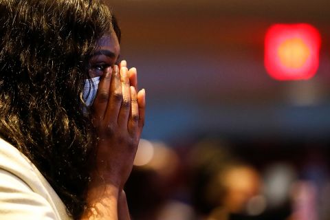 A woman reacts during Thursday's service.