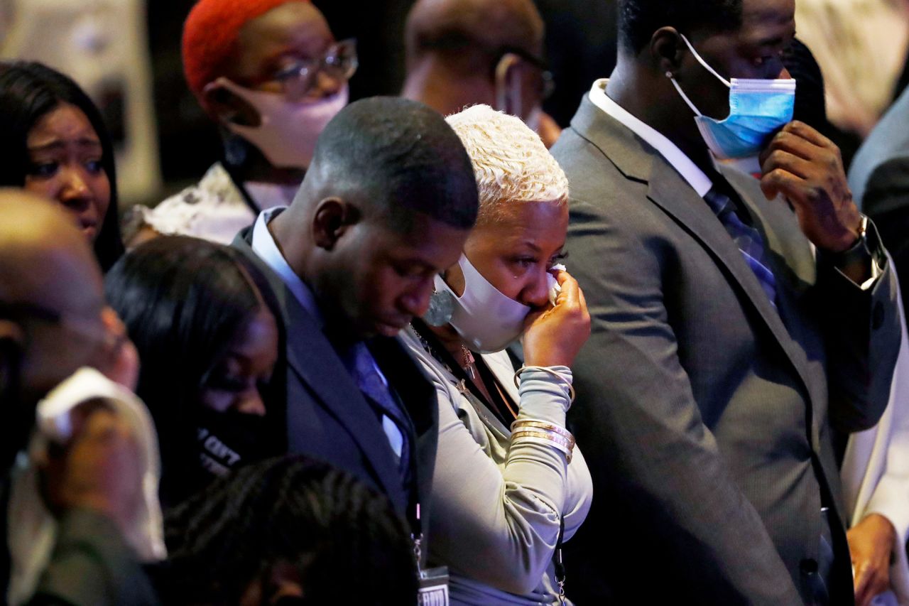 People at the Minneapolis memorial stood in silence for eight minutes and 46 seconds -— the length of time that Derek Chauvin, the former Minneapolis police officer charged with killing Floyd, had his knee on Floyd's neck. At center here is Floyd's cousin Shareeduh Tate, who grew up with him and spoke during the service.