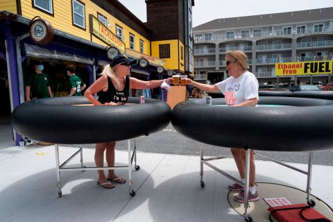 People try out <a href="https://www.cnn.com/travel/article/coronavirus-restaurant-bumper-tables-trnd/index.html" target="_blank">social-distancing "bumper tables"</a> as the Fish Tales restaurant opened for in-person dining in Ocean City, Maryland, on May 29, 2020.