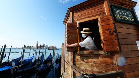 A gondoliere opens a kiosk for people wanting to go for a gondola ride in May.