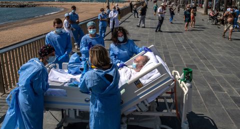 Isidre Correa, who is recovering from the coronavirus, is taken to the seaside in Barcelona, Spain, on June 3, 2020. Hospital del Mar has been taking patients to the seaside as part of the recovery process.