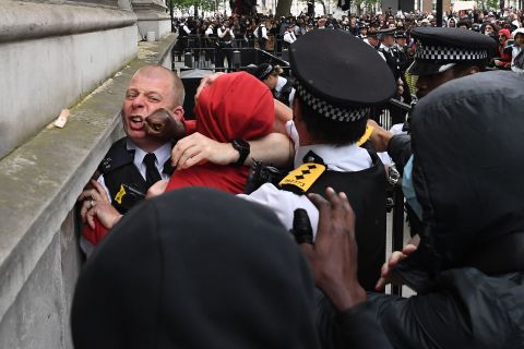 Police officers scuffle with a protester during an anti-racism demonstration in London on Wednesday, June 3. The death of George Floyd <a href="https://edition.cnn.com/2020/06/03/uk/black-lives-matter-protest-london-george-floyd-gbr-intl/index.html" target="_blank">has resonated around the world.</a> In London — some 4,000 miles from where Floyd died in Minnesota — thousands of protesters gathered to show solidarity with mourning Americans.