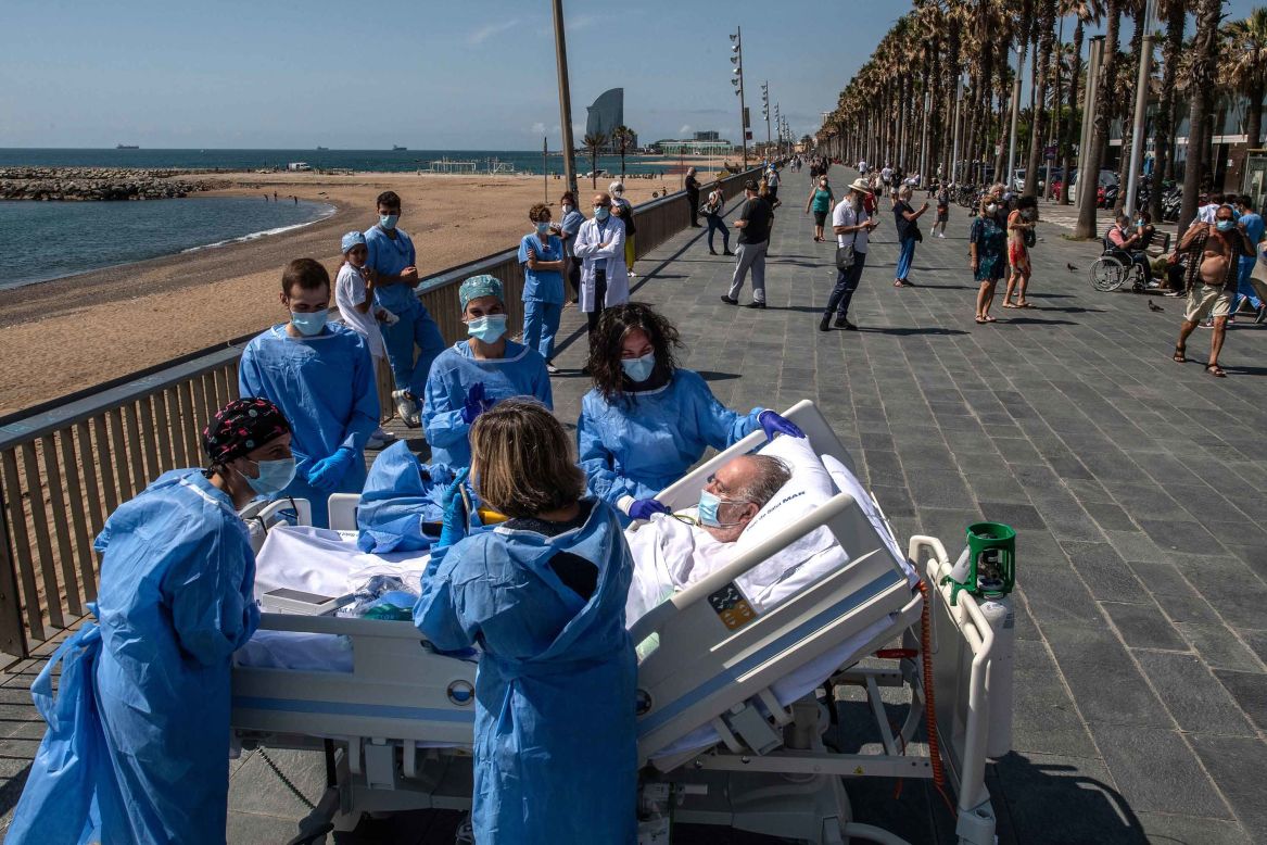 Isidre Correa, who is recovering from the coronavirus, is taken to the seaside in Barcelona, Spain, on Wednesday, June 3. Hospital del Mar has been taking coronavirus patients to the seaside as part of the recovery process.