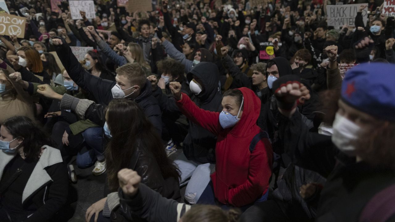 Protesters raise their fists during a Black Lives Matter rally on Tuesday in Sydney.