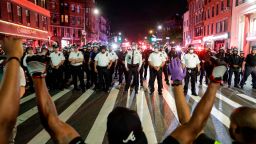 Protesters take a knee on Flatbush Avenue in front of New York City police officers during a solidarity rally for George Floyd, Thursday, June 4, 2020, in the Brooklyn borough of New York. Floyd died after being restrained by Minneapolis police officers on May 25. (AP Photo/Frank Franklin II)